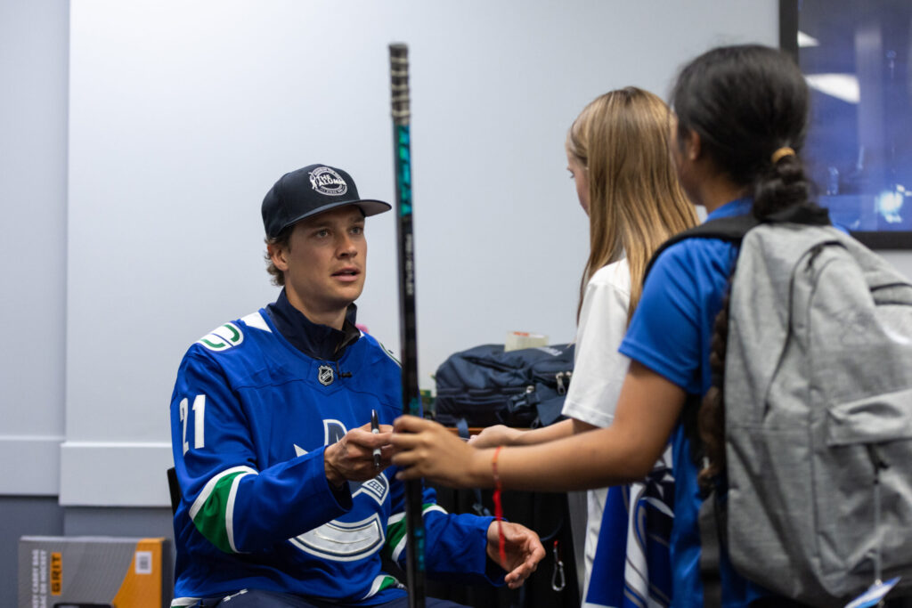 Canucks player signing autographs