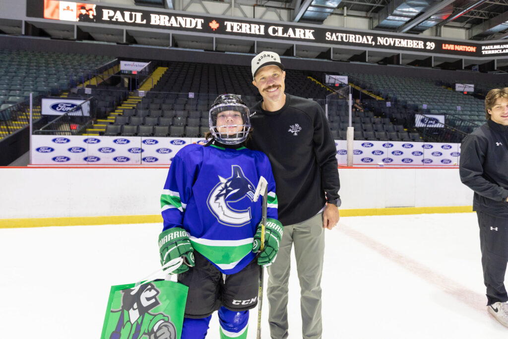 Young player in full gear with coach