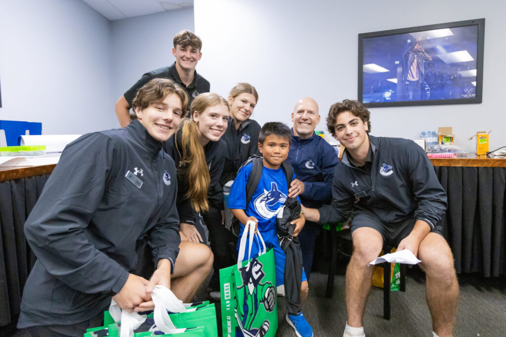 Camp staff with camper and swag bags