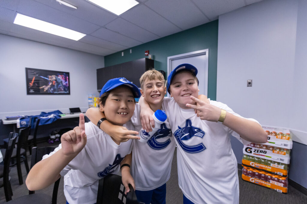 Kids posing in Canucks jerseys