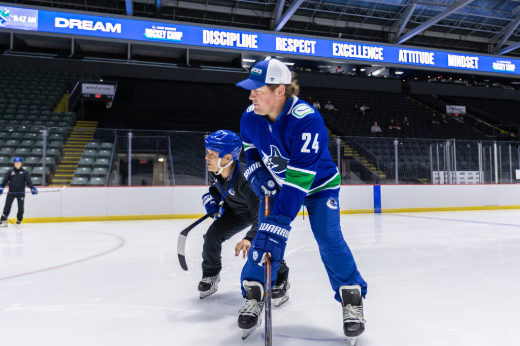 Canucks player with camper on ice