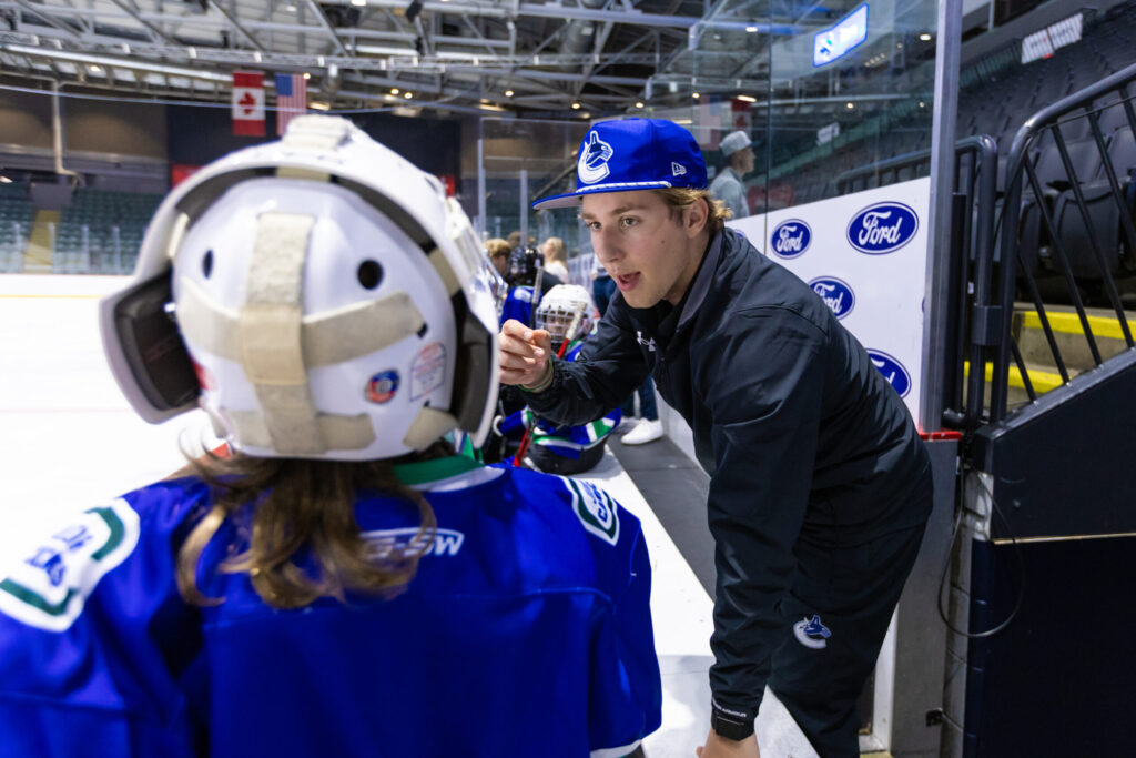 Coach fist-bumping player at boards